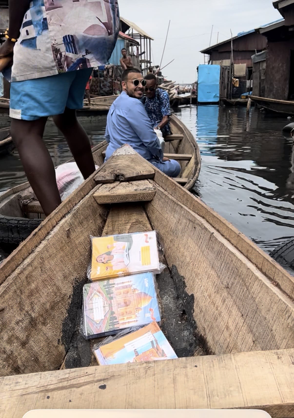 Books and learning materials being transported by canoe to a waterside community in Africa