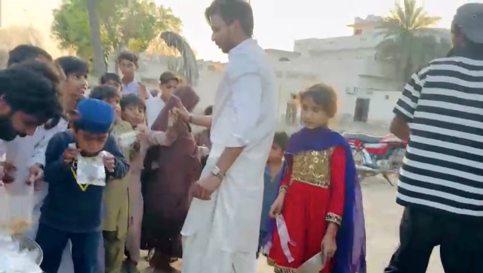 Children receiving packed meals during a community food distribution