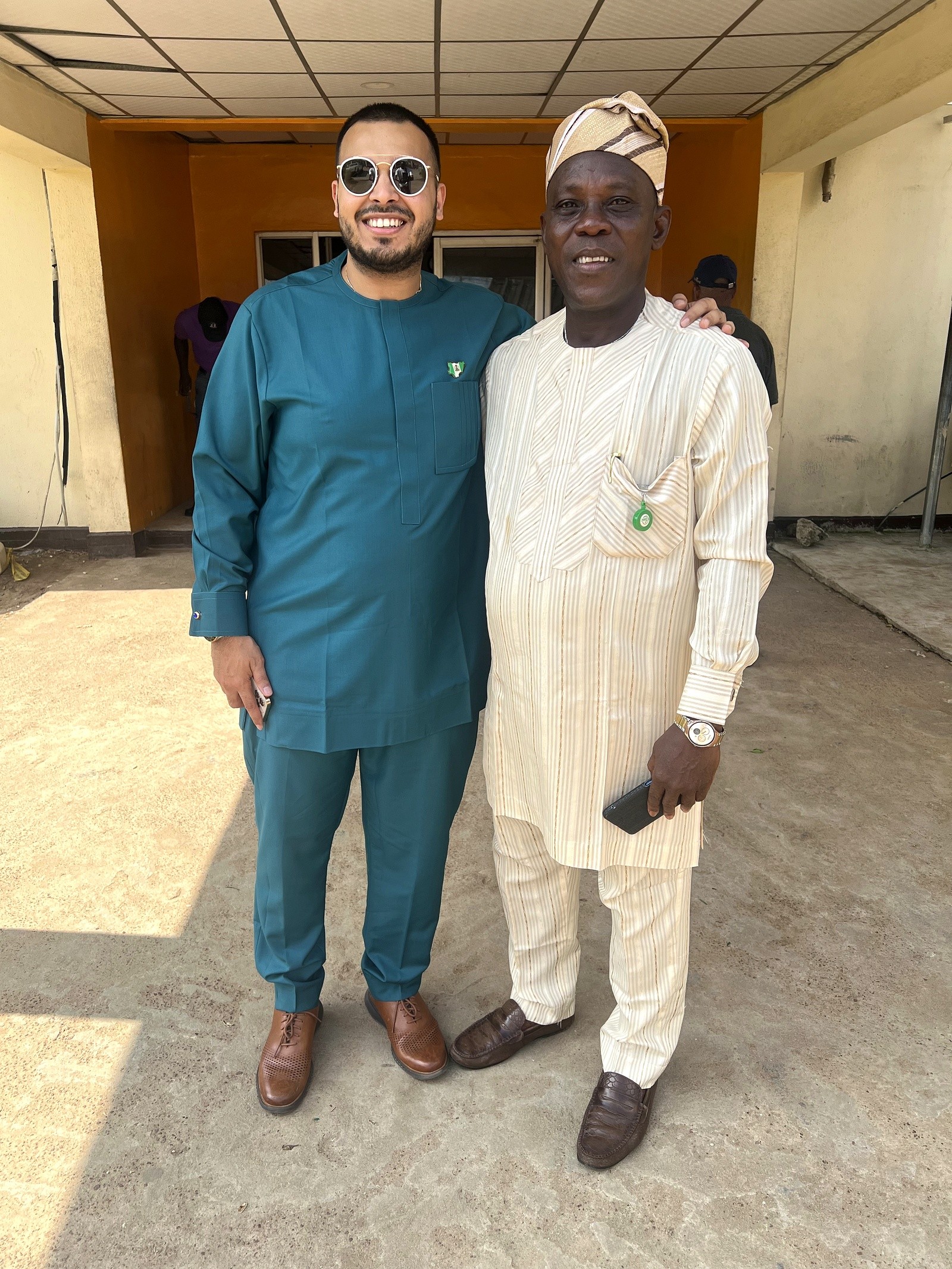 Two men standing together outside a community building