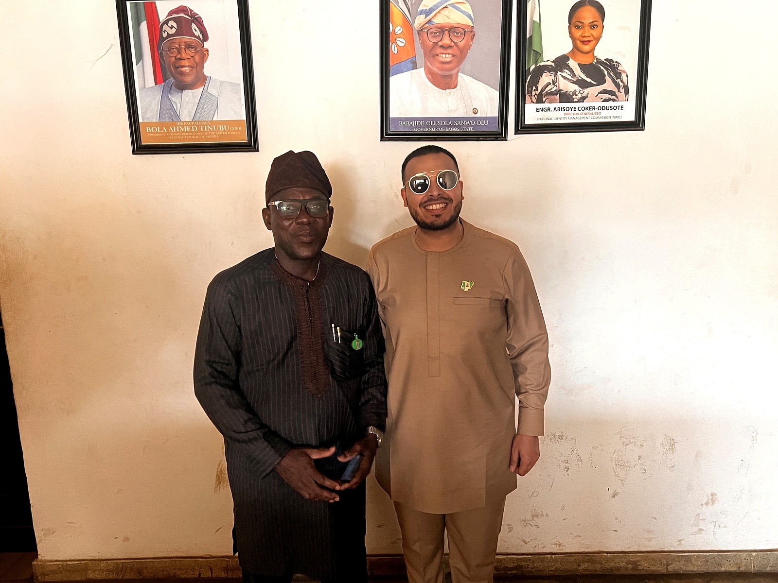 Two men standing together inside a local office
