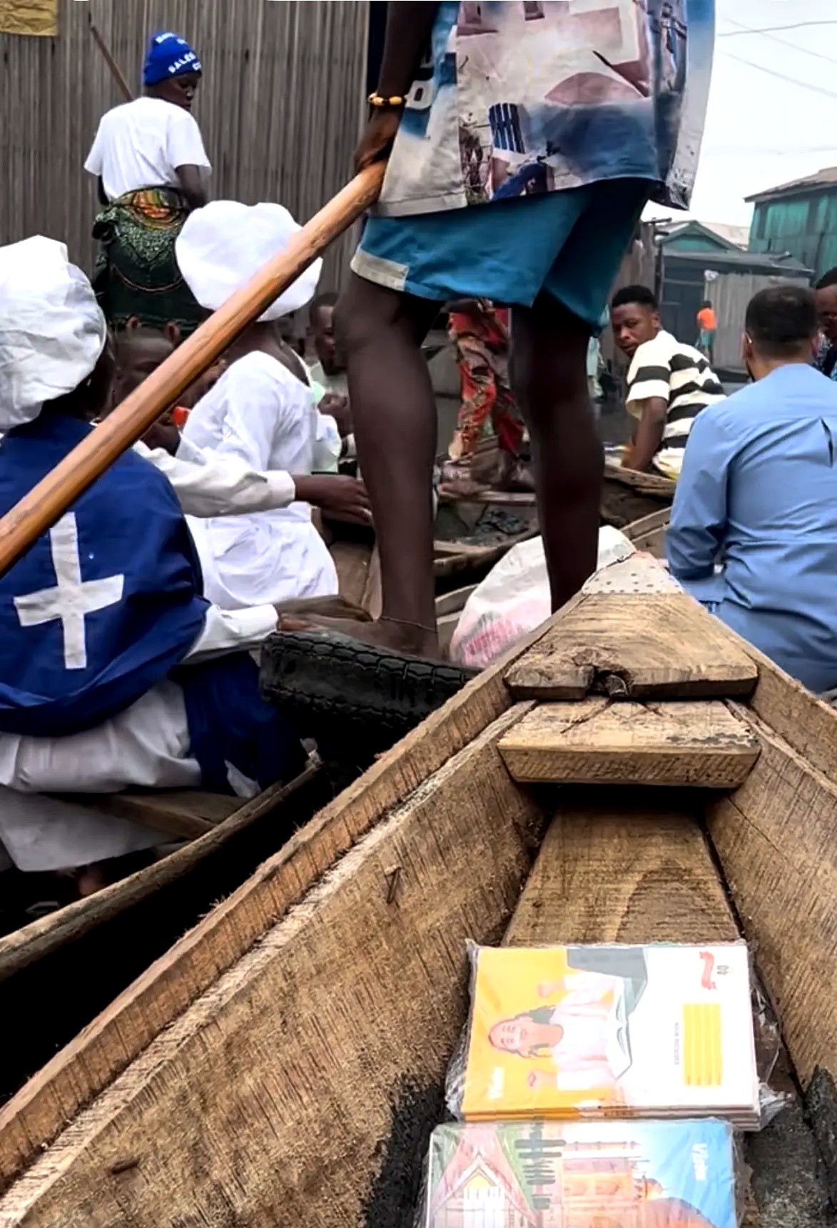School books stacked inside a wooden canoe in a waterside community